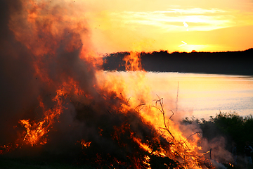 Image showing Outdoor fire nearby a lake in the summer in Denmark