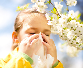 Image showing Little girl is blowing her nose