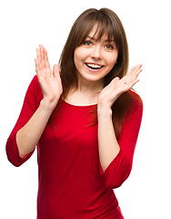 Image showing Woman is holding her face in astonishment