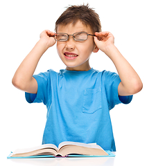 Image showing Little boy is reading a book