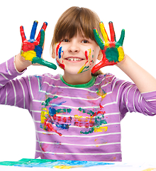 Image showing Portrait of a cute girl playing with paints