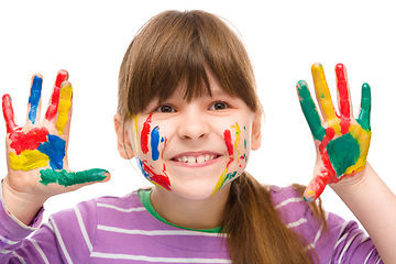 Image showing Portrait of a cute girl playing with paints