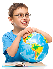 Image showing Little boy is holding globe