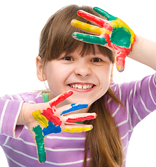 Image showing Portrait of a cute girl playing with paints