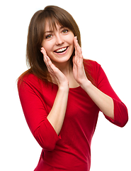 Image showing Woman is holding her face in astonishment