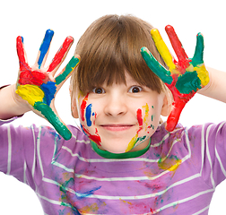 Image showing Portrait of a cute girl playing with paints