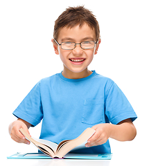 Image showing Little boy is reading a book