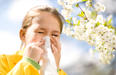 Image showing Little girl is blowing her nose