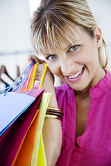 Image showing young pretty smiling woman with shopping bags