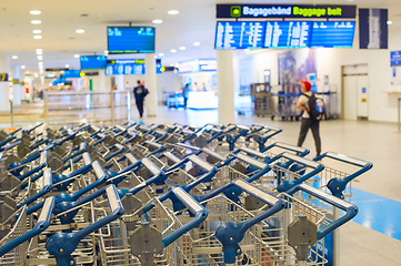 Image showing Baggage trolleys at airport terminal