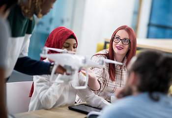 Image showing multiethnic business team learning about drone technology