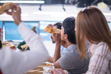 Image showing multiethnic business team eating pizza