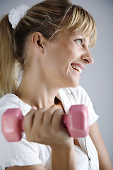Image showing smiling female with dumbell