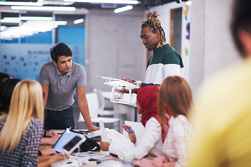 Image showing multiethnic business team learning about drone technology