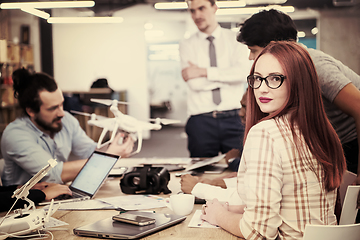 Image showing redhead business woman learning about drone technology