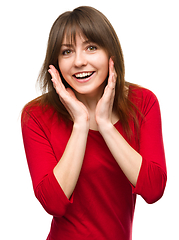 Image showing Woman is holding her face in astonishment