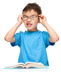 Image showing Little boy is reading a book