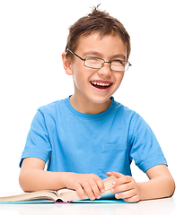 Image showing Little boy is reading a book