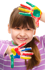 Image showing Portrait of a cute girl playing with paints