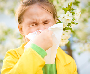 Image showing Little girl is blowing her nose