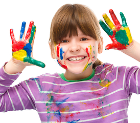 Image showing Portrait of a cute girl playing with paints