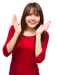 Image showing Woman is holding her face in astonishment