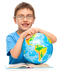 Image showing Little boy is holding globe