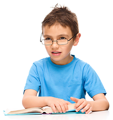 Image showing Little boy is reading a book