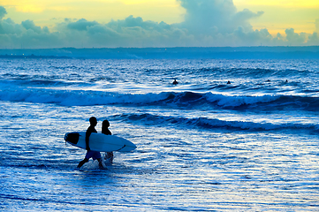 Image showing Silhouette of surfers couple