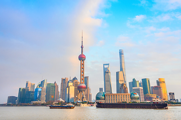 Image showing Shanghai skyline, barges by waterfront