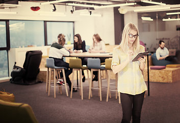 Image showing blonde businesswoman working online using digital tablet