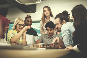 Image showing multiethnic group of business people playing chess