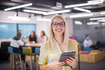 Image showing blonde businesswoman working online using digital tablet