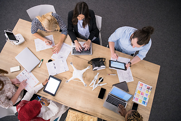 Image showing top view of multiethnic business team learning about drone techn