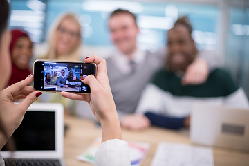 Image showing businesswoman using mobile phone for taking photo