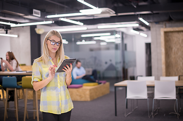 Image showing blonde businesswoman working online using digital tablet