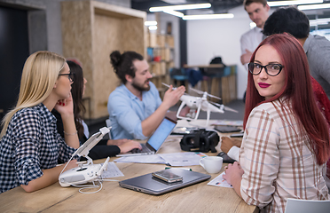 Image showing redhead business woman learning about drone technology