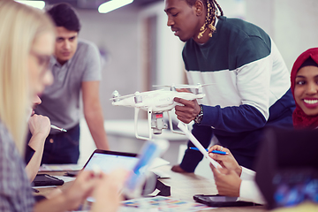 Image showing multiethnic business team learning about drone technology