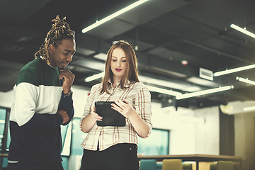 Image showing multiethnic business couple using a tablet computer