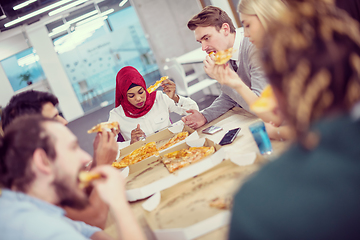 Image showing multiethnic business team eating pizza