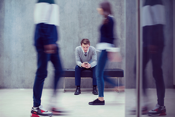 Image showing businessman using mobile phone while sitting on the bench