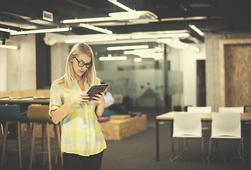 Image showing blonde businesswoman working online using digital tablet