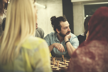 Image showing multiethnic group of business people playing chess