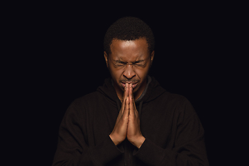 Image showing Close up portrait of young man isolated on black studio background