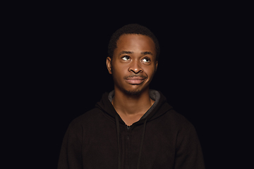 Image showing Close up portrait of young man isolated on black studio background