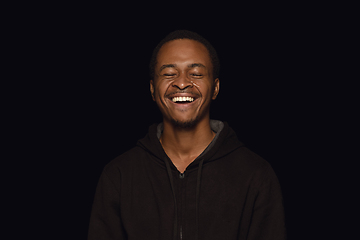 Image showing Close up portrait of young man isolated on black studio background