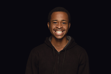 Image showing Close up portrait of young man isolated on black studio background