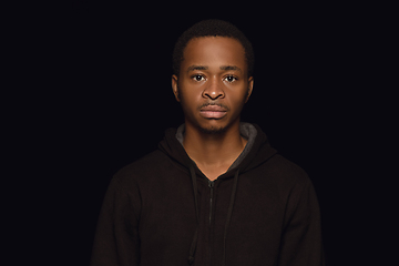 Image showing Close up portrait of young man isolated on black studio background