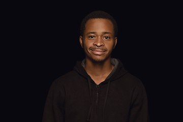 Image showing Close up portrait of young man isolated on black studio background