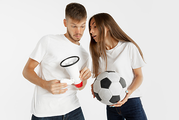 Image showing Portrait of beautiful couple football fans on white studio background